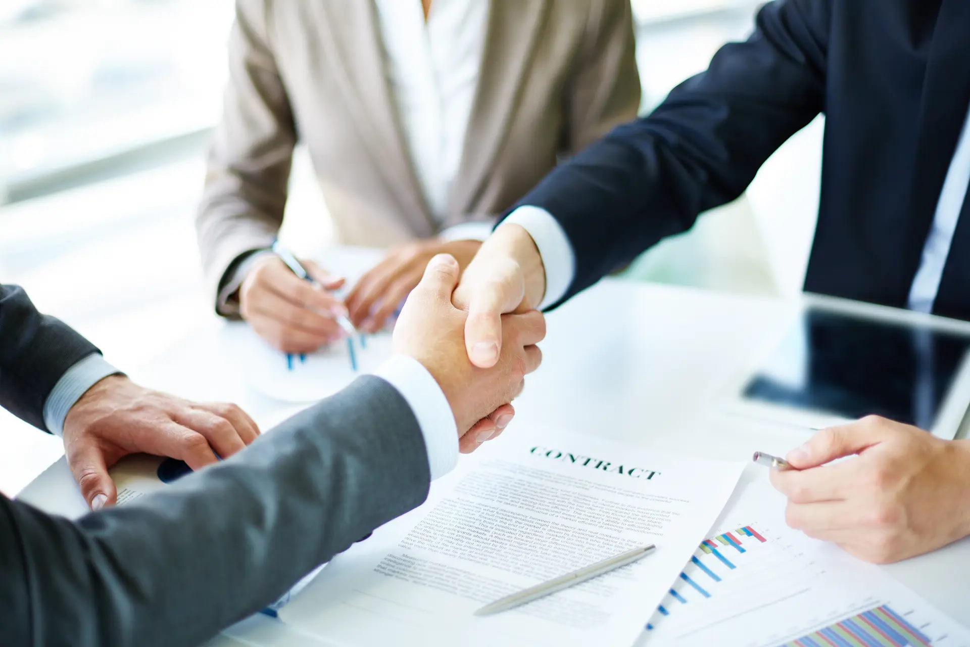 Business_partners_shaking_hands_after_signing_a_security_service_contract