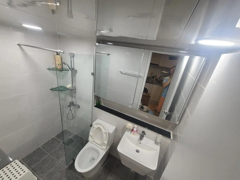 Compact bathroom with a glass shower, toilet, and wall sink (Listing ID : 16580)