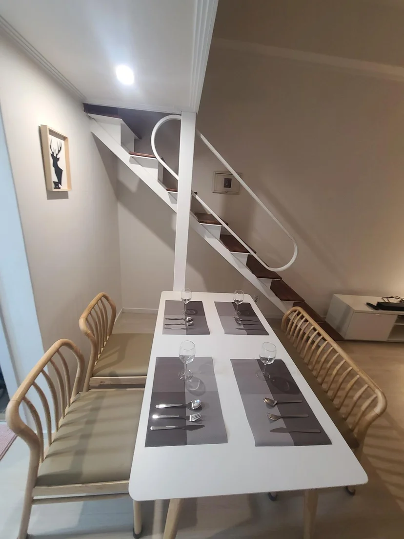 Dining table set for four beside the loft staircase (Listing ID : 16580)