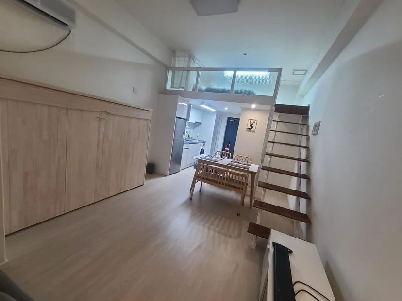 Loft studio with a dining area and a staircase up to the sleeping loft (Listing ID : 16580)
