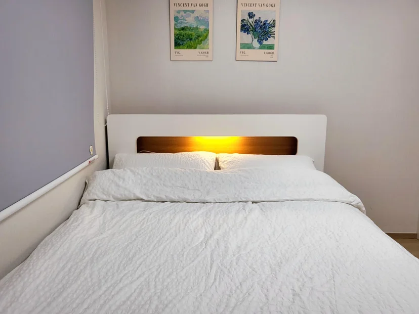 Bedroom with a white bed and warm headboard lighting (Listing ID : 3535)