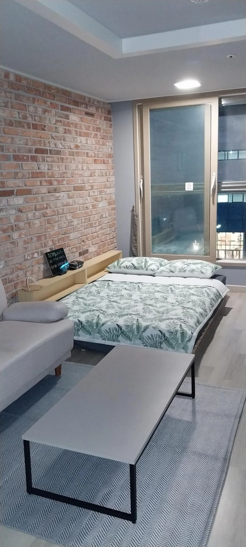 Bedroom corner with a double bed and a city-view window (Listing ID : 14737)