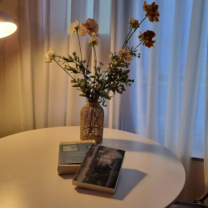 Side table styled with a rattan vase, dried flowers, and books (Listing ID : 15851)