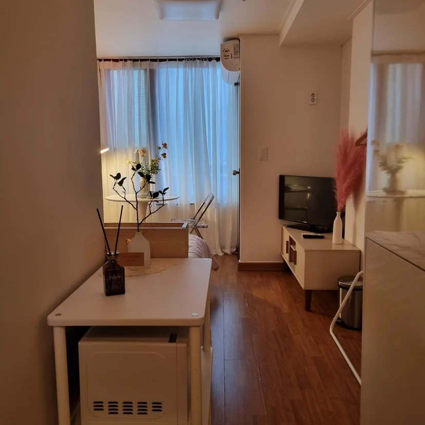 Cozy lounge nook with leather armchair, tea table, and curtained window (Listing ID : 15851)