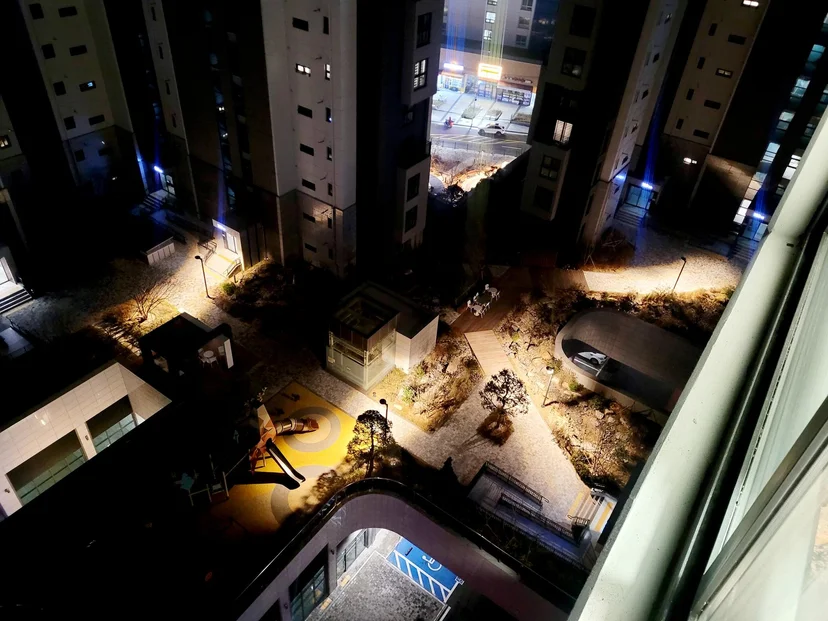 Lit courtyard and playground at night seen from the window (Listing ID : 20352)