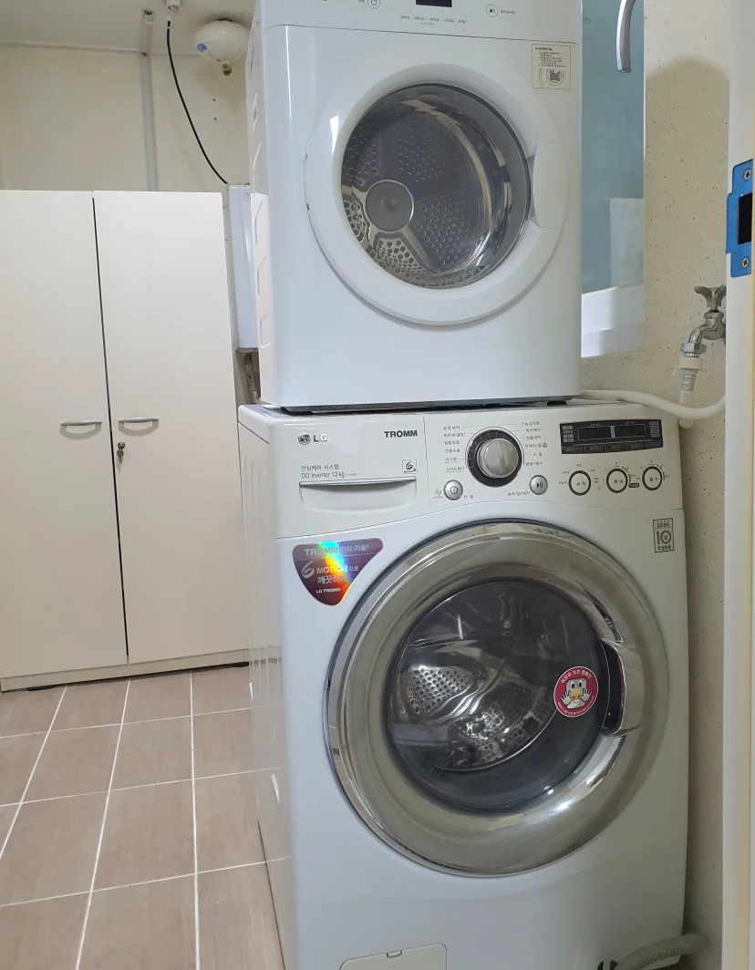 Stacked LG washer and dryer in a utility nook (Listing ID : 43566)
