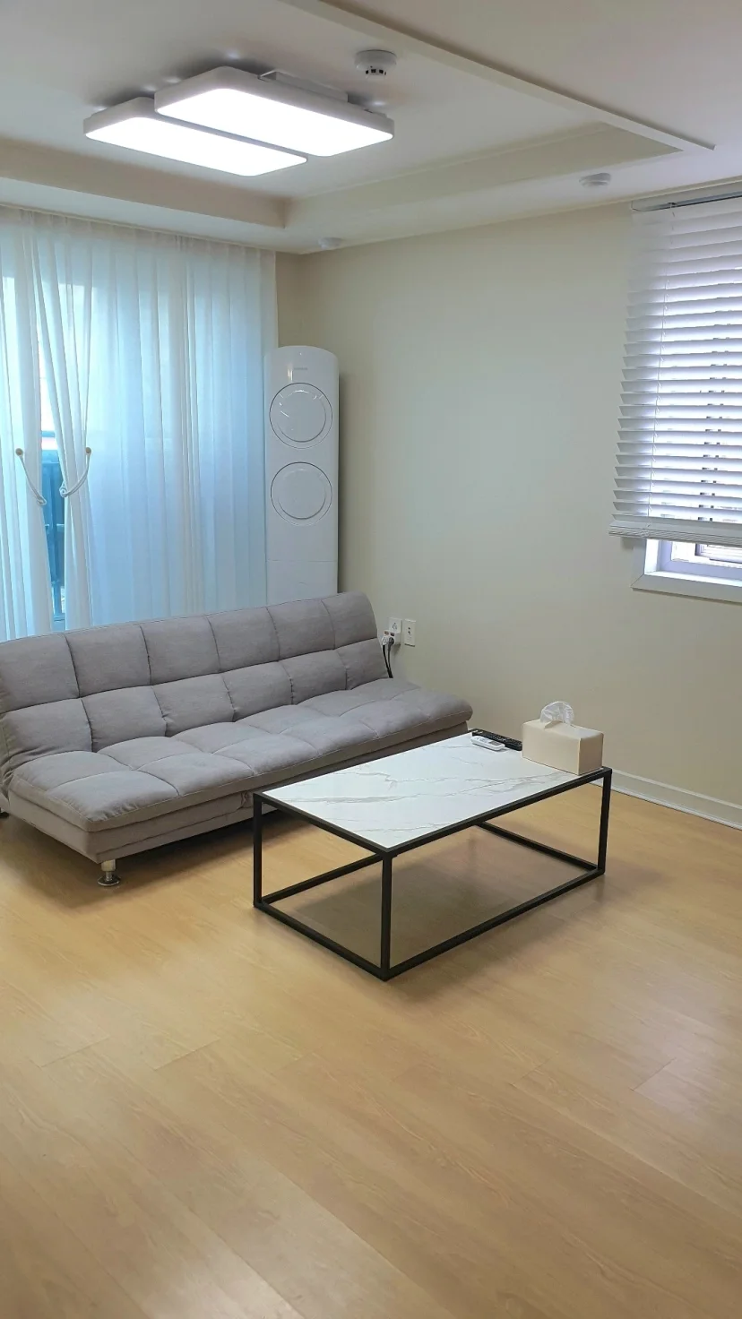 Living room with a gray sofa and low coffee table (Listing ID : 43566)
