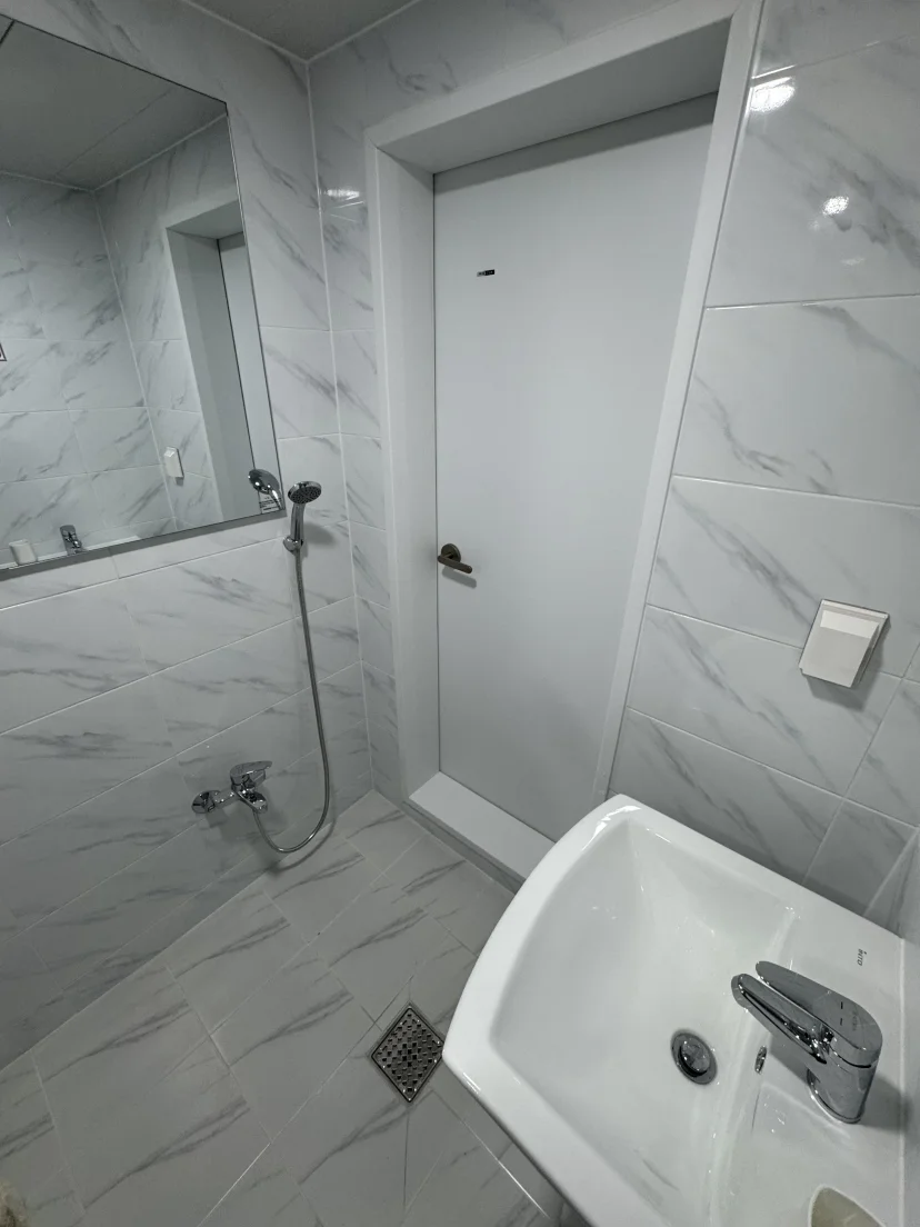 White marble bathroom with a bathtub and wall shower (Listing ID : 45817)