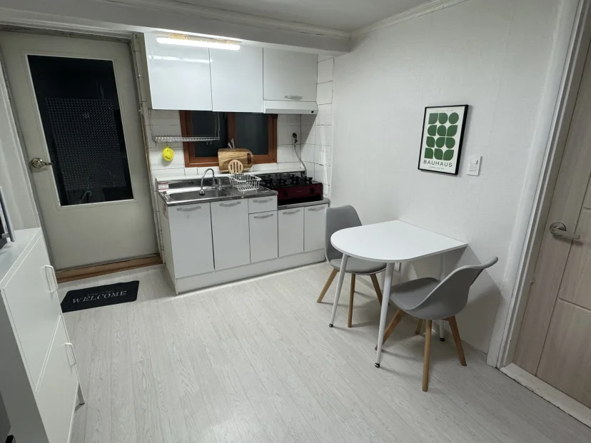 Kitchen with white cabinets, a cooktop and a dining area (Listing ID : 45817)