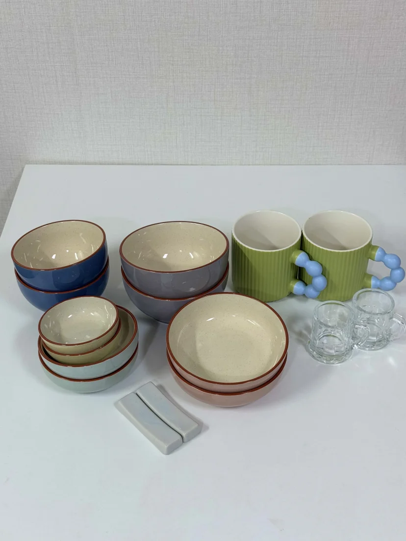 Ceramic bowls, mugs and glass cups laid out on a table (Listing ID : 45817)
