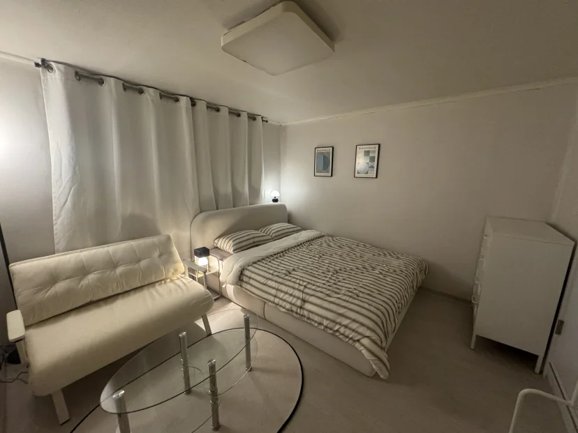 Bedroom with a double bed, white sofa and glass table (Listing ID : 45817)