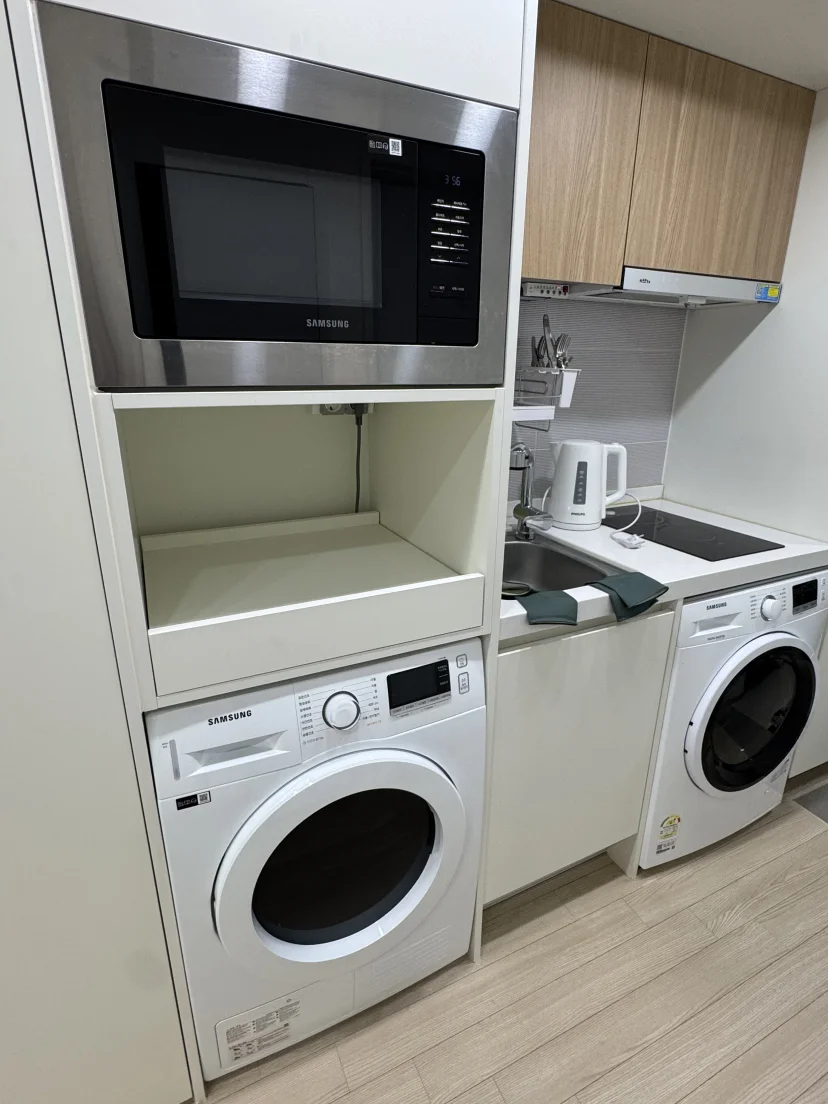 Compact officetel kitchen with microwave, induction stove, washer and dryer column (Listing ID : 45885)