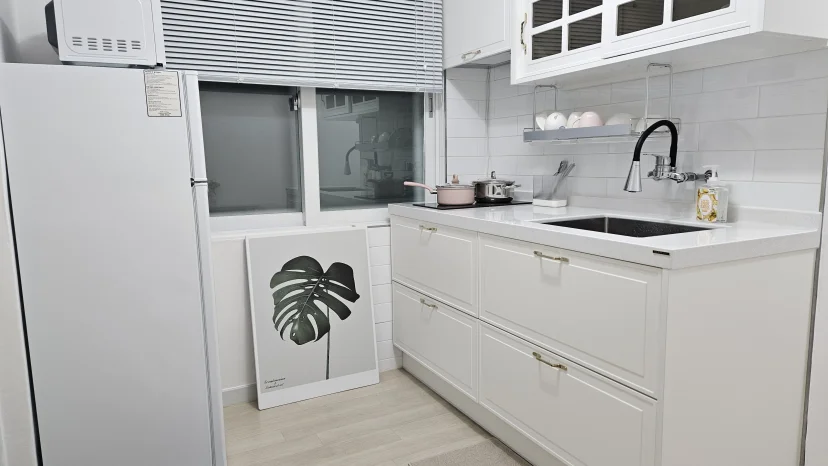 Compact white kitchen with refrigerator, induction cooktop, and sink (Listing ID : 46906)