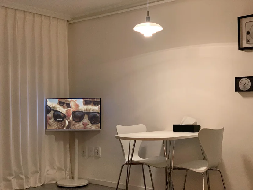 Living area with curtains, wall-mounted TV and a small table (Listing ID : 38554)