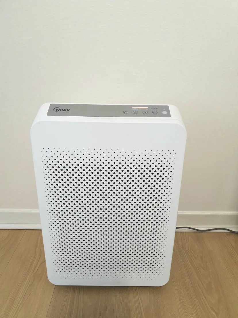 White Winix air purifier on wood floor against a white wall (Listing ID : 43566)