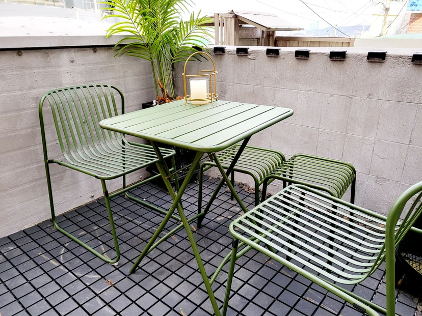 Green bistro table and chairs on a tiled outdoor deck (Listing ID : 37856)