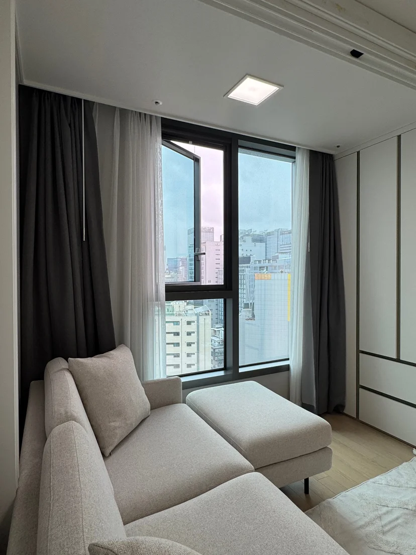 Bedroom with a wood-framed bed and a zebra-blind window (Listing ID : 10891)