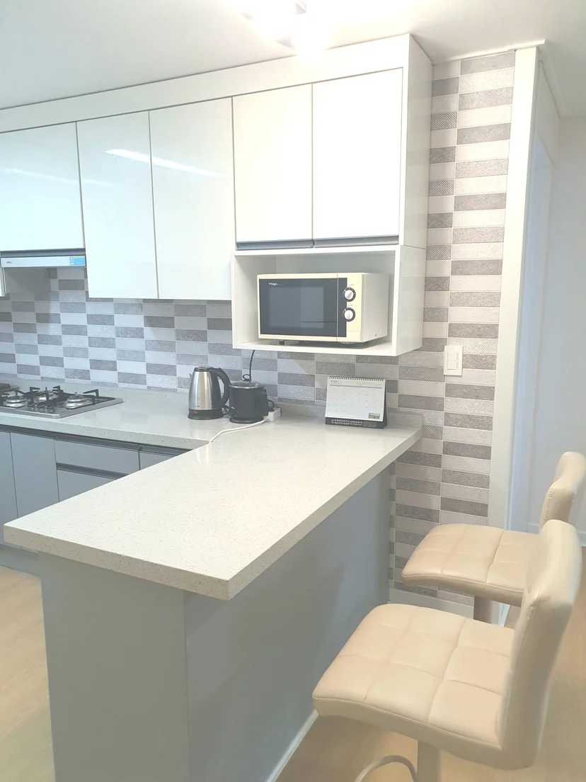 Kitchen bar counter with cream stools and white cabinetry (Listing ID : 43566)