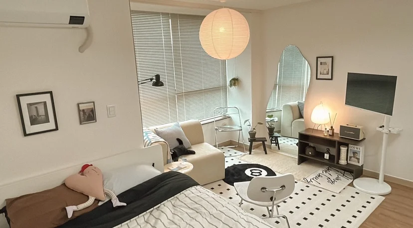 Studio living space with bed, sofa, paper lantern pendant and wall-mounted TV (Listing ID : 31659)