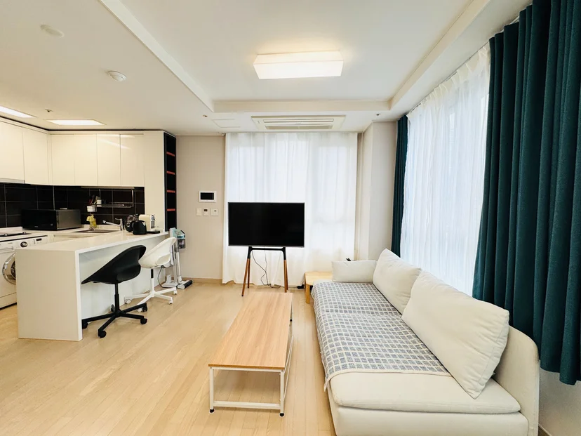 Open-plan studio with a long sofa and floor-to-ceiling windows (Listing ID : 39296)