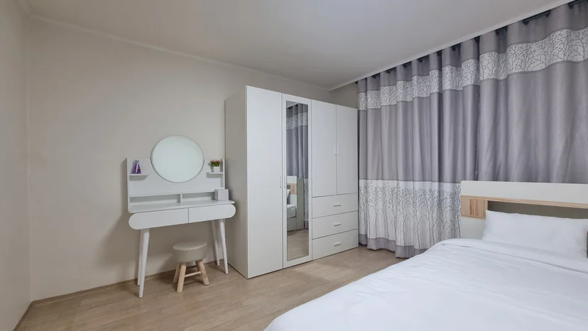 Main bedroom with a queen bed, white wardrobe and vanity (Listing ID : 37082)