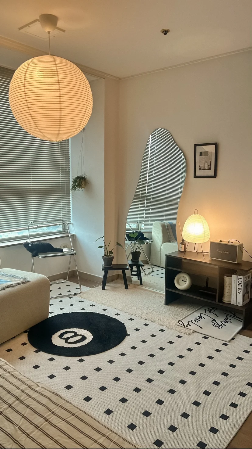 Cozy studio living area with paper lantern, full-length mirror, and patterned accent rug (Listing ID : 31659)