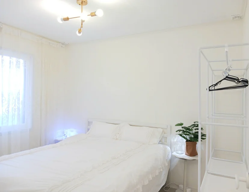 Bright bedroom with a sheer-curtain window and pendant light (Listing ID : 29514)