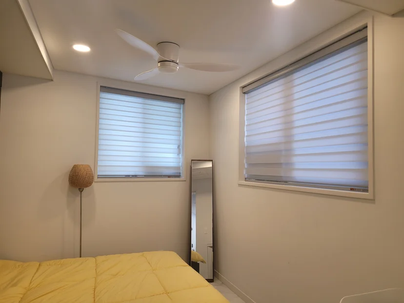 Bright bedroom with ceiling fan and large windows (Listing ID : 40873)
