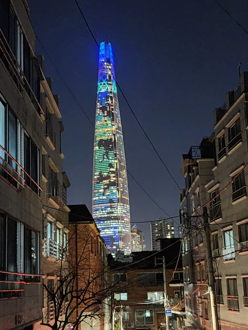 Night view down the alley toward an illuminated tower (Listing ID : 47877)