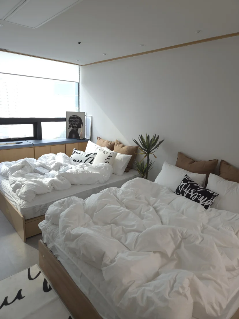 Two neatly made beds by the window (Listing ID : 48330)