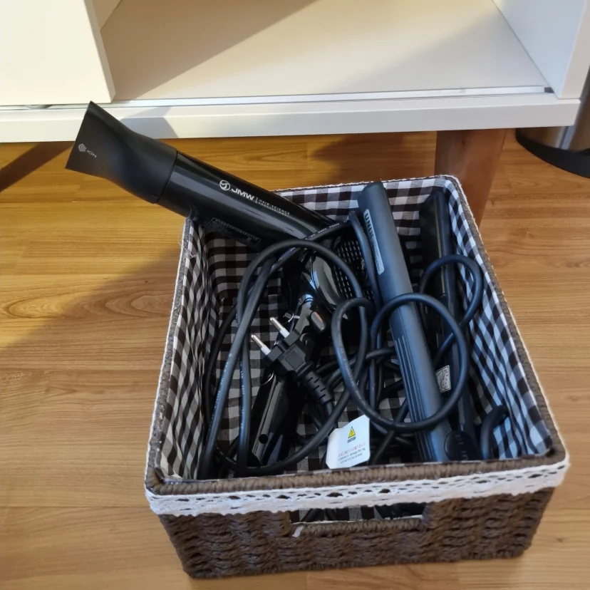 Hair dryer and curling iron tucked into a woven storage basket (Listing ID : 15851)