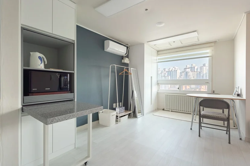 Living area with a window desk, microwave nook and clothes rack (Listing ID : 32541)