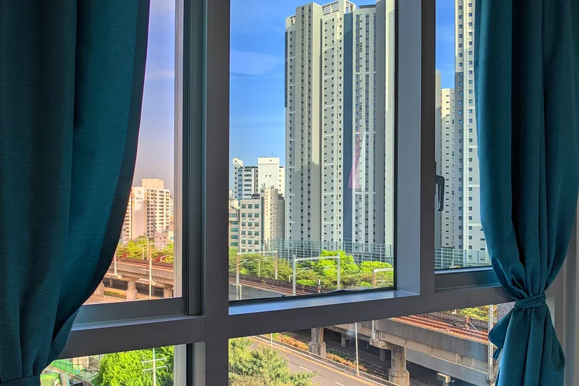 Floor-to-ceiling window framing a high-rise city view (Listing ID : 23498)
