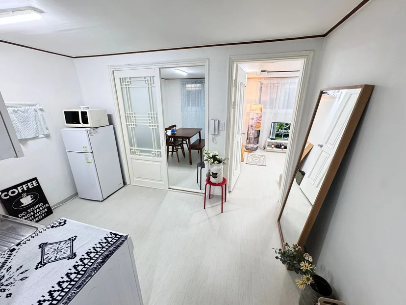 Bright entry and living area with a floor mirror and sliding door (Listing ID : 26009)