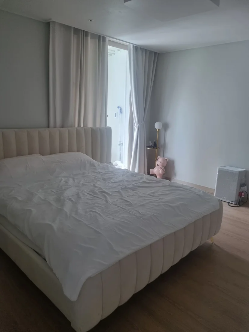 Bedroom with an upholstered bed and a balcony door (Listing ID : 26688)