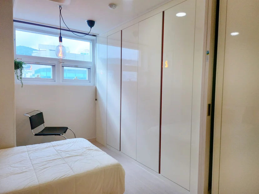 Bedroom with a wardrobe, chair and window in a new-build studio (Listing ID : 27331)