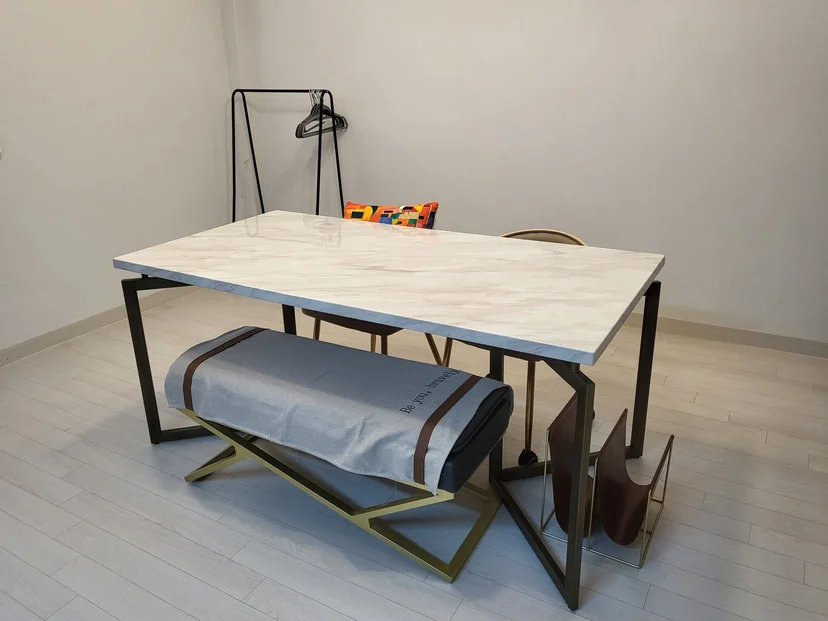 Marble dining table with metal frame, bench, coat rack in studio interior (Listing ID : 24807)