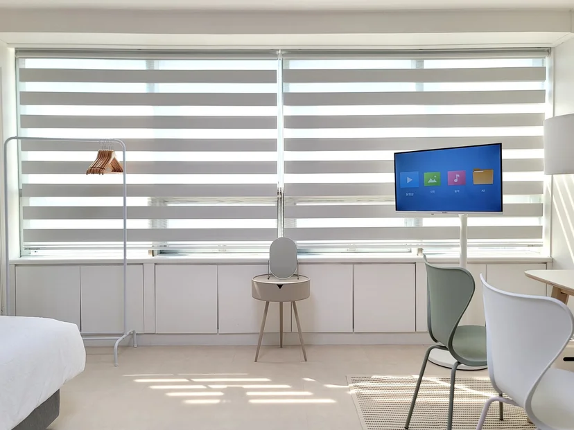 Wide window wall with a vanity, chair and TV (Listing ID : 29409)