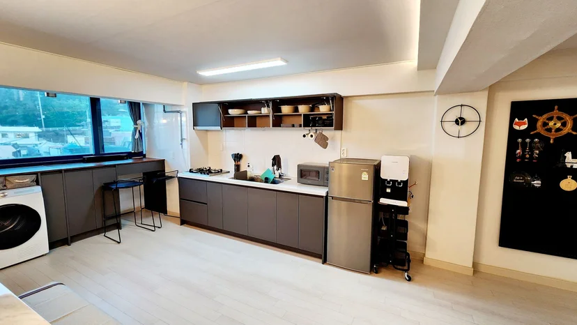 Wooden desk with laptop and lamp beside large windows (Listing ID : 24807)