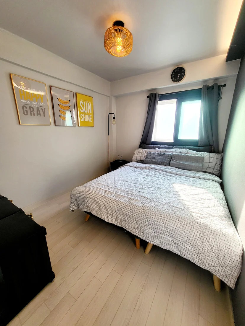 Cozy bedroom with double bed, rattan pendant light, and yellow wall art (Listing ID : 24807)
