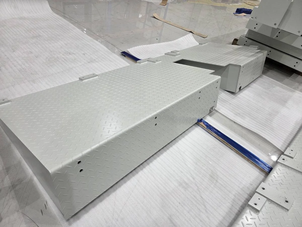 CNC machined checker plate assembly with structural supports for battery factory