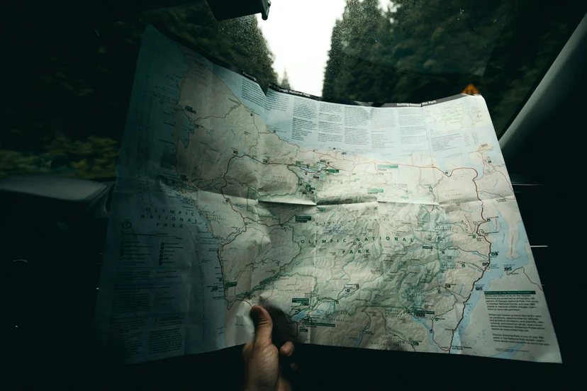 Person holding a smartphone displaying a map navigation app, useful for finding directions while traveling in Korea