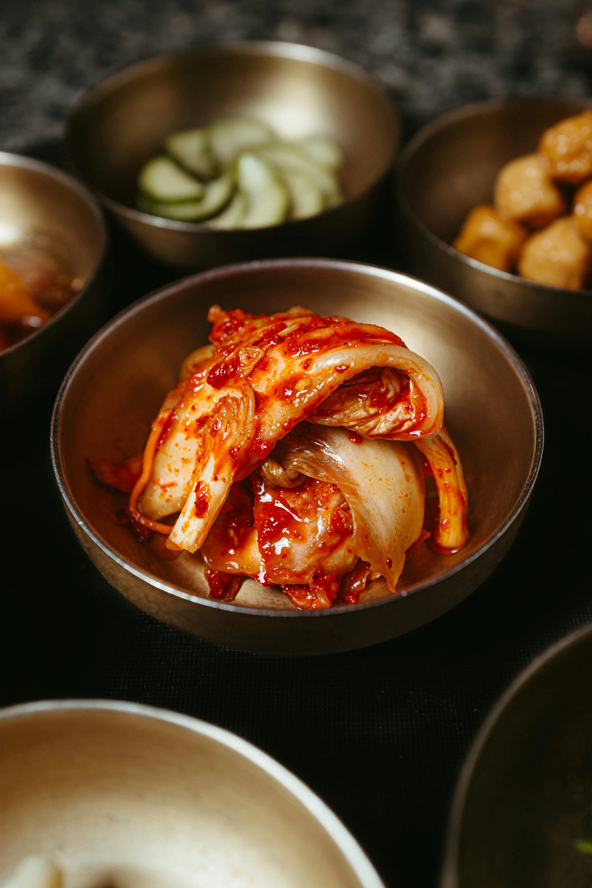 A Korean dining table filled with bowls of food and side dishes (banchan), showcasing the communal style of Korean meals