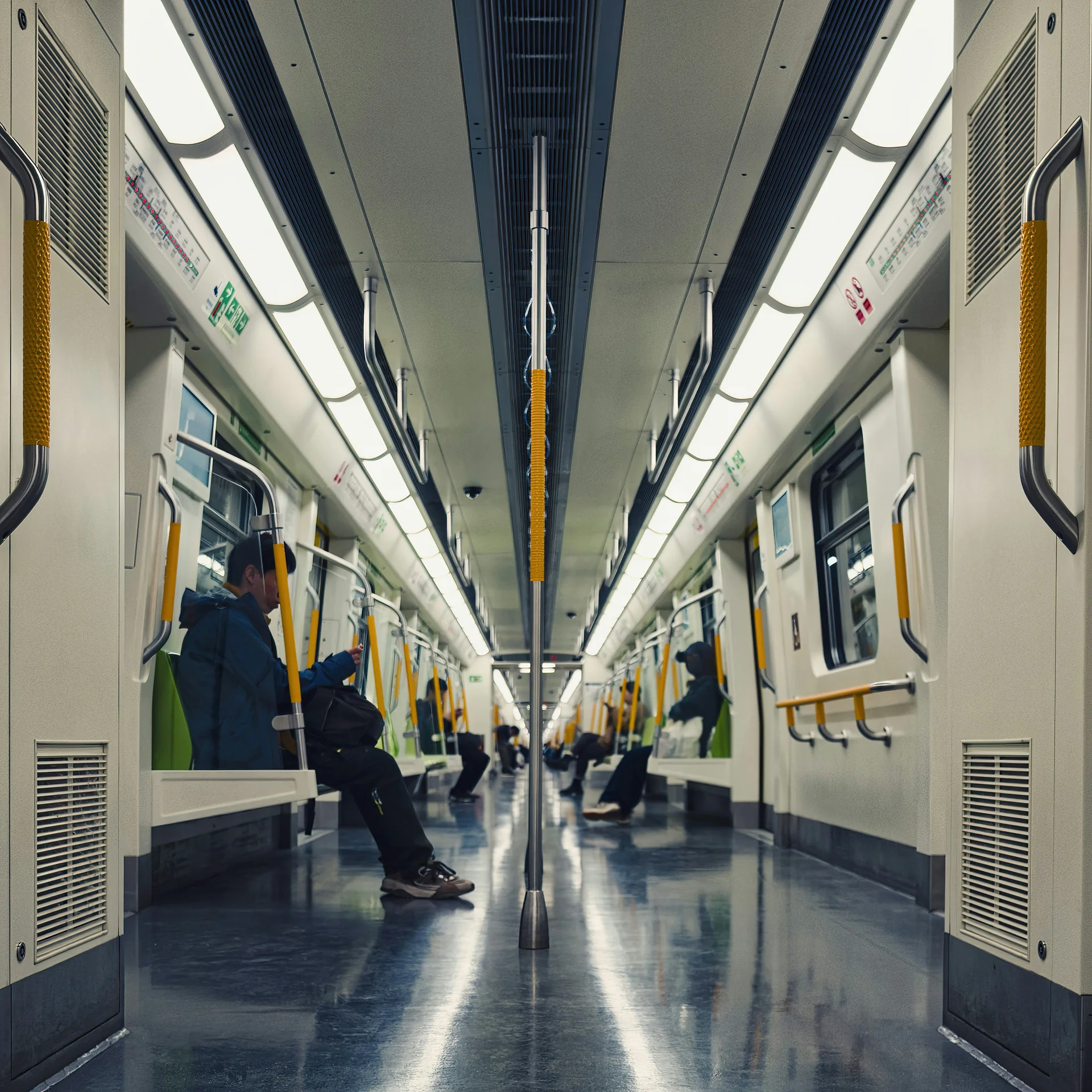 Interior view of a modern subway train with passengers seated quietly, reflecting the calm and orderly atmosphere of public transit in Korea