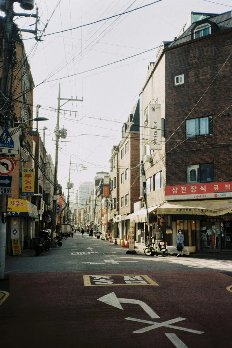 Vibrant Hongdae street in Seoul lined with colorful signs, shops, and cafes in the university district