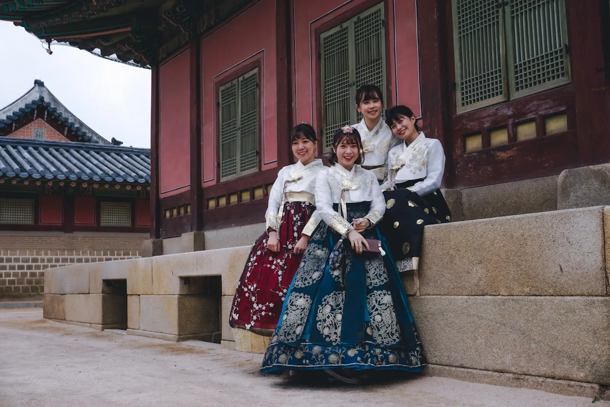 Visitors wearing hanbok at a Seoul palace courtyard