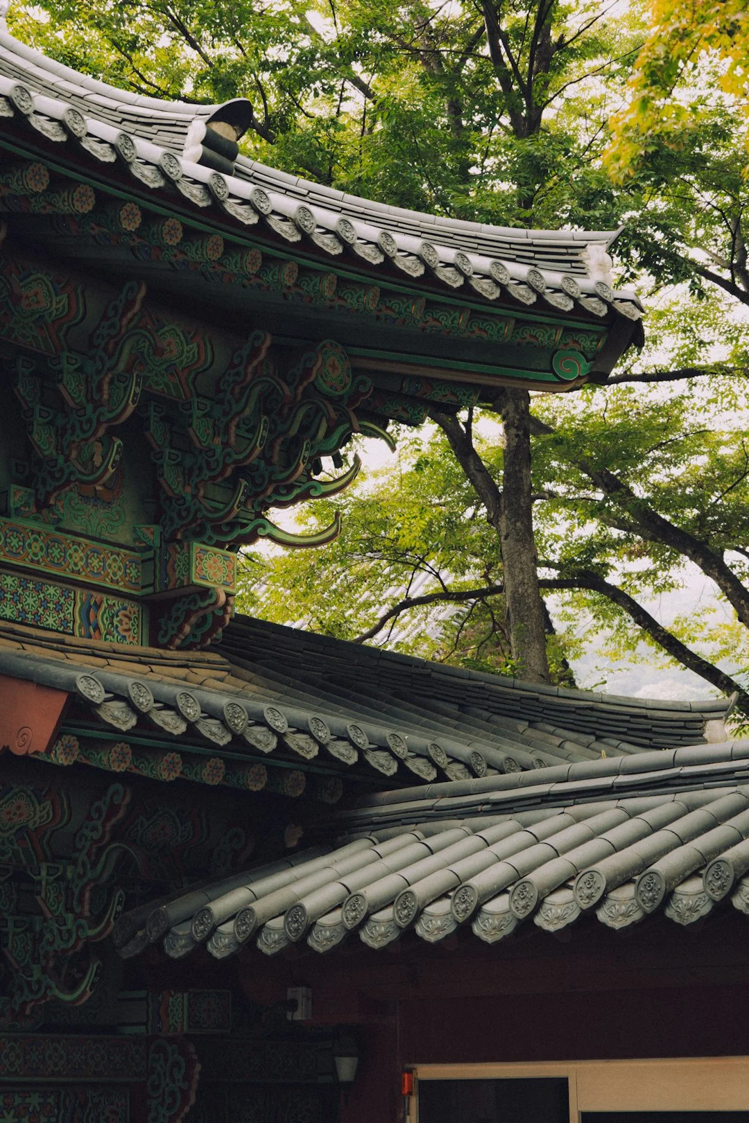 Traditional Korean temple roof with intricate carvings and colorful paintwork