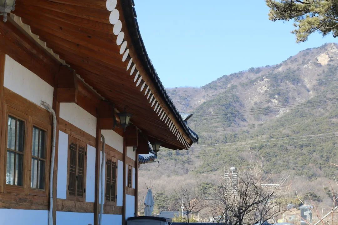 Traditional Korean temple with mountains in the background