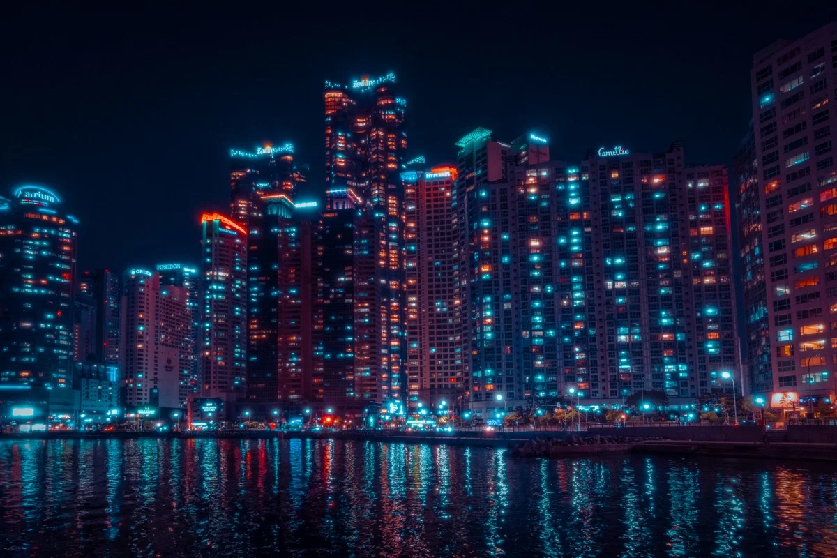 Busan city lights reflecting on the water at night near Gwangalli