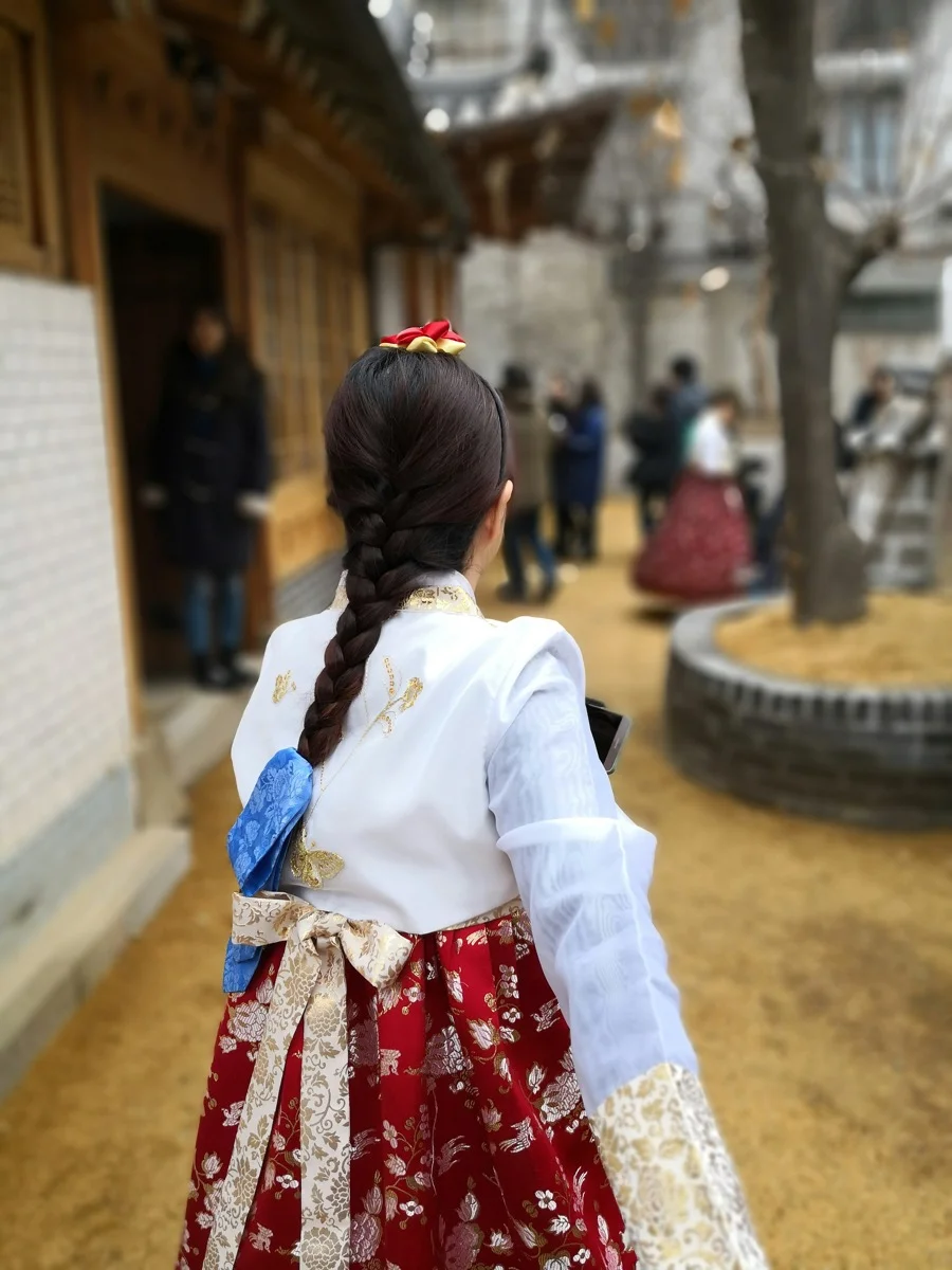Narrow alleyway with murals and art installations in Gamcheon Culture Village, Busan